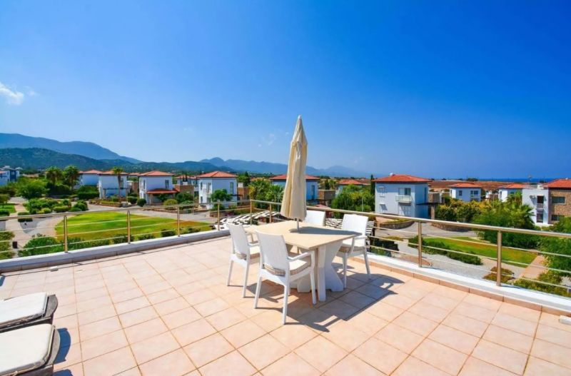 Terrace of a 2-bedroom apartment in Tatlisu with mountain and sea views.
