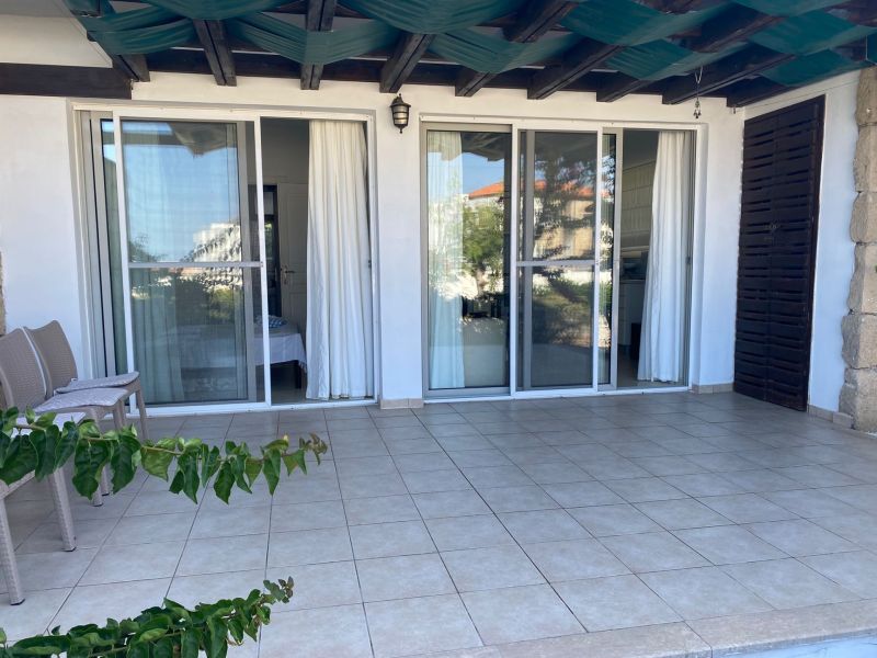 Entrance terrace in a 2-bedroom apartment in Tatlisu with sliding glass doors.