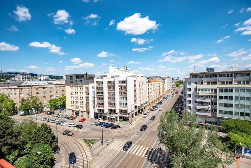 View of Krížna Street in Bratislava - Old Town with buildings and greenery.