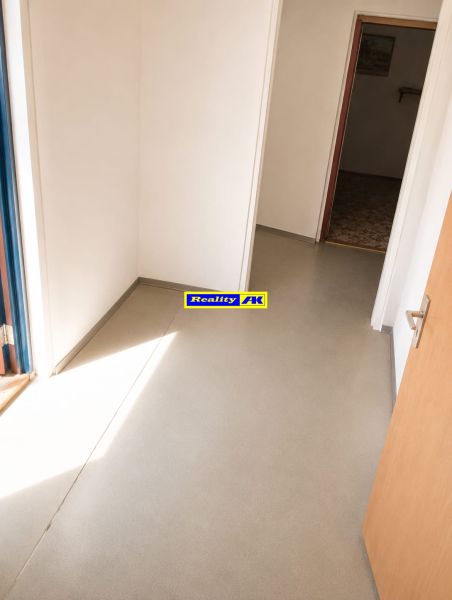 A hallway with simple white walls and a light floor in a 3-room apartment.