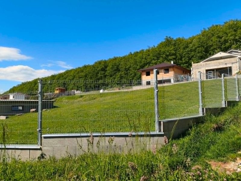 Residential plots in Horná Ves with fencing and views of the surrounding forests.