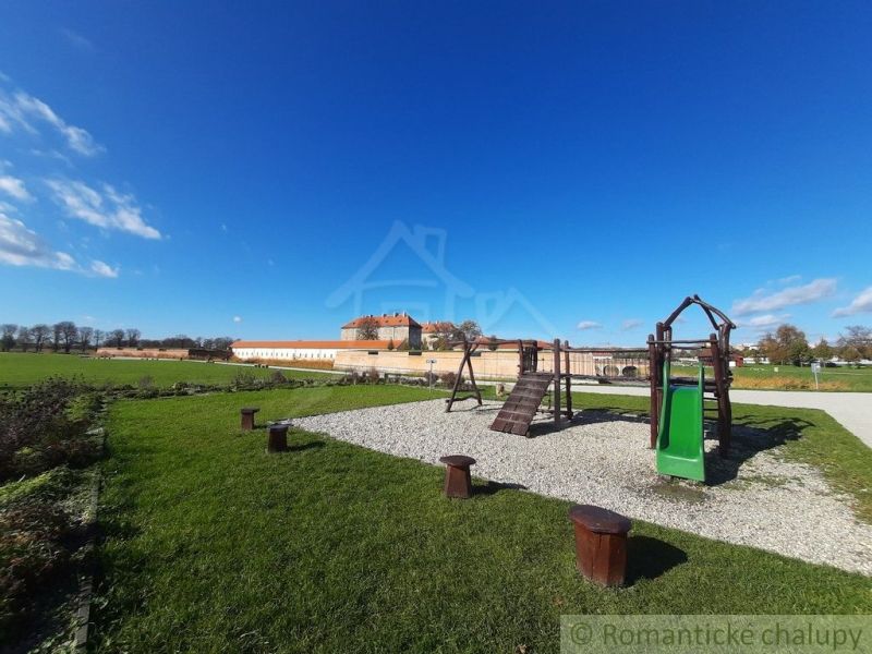 A children's playground near the cottage in Holíč, with an architectural monument in the background.