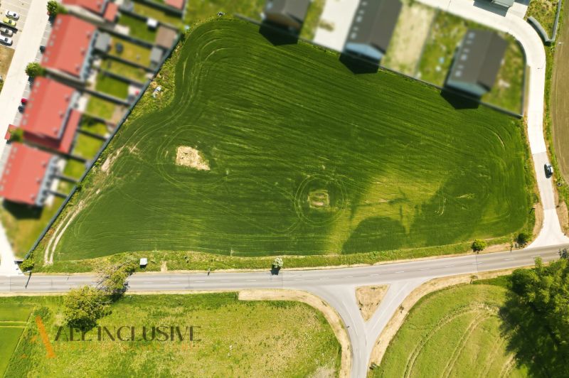 Aerial view of residential plots in Lehnice with green areas and roads.