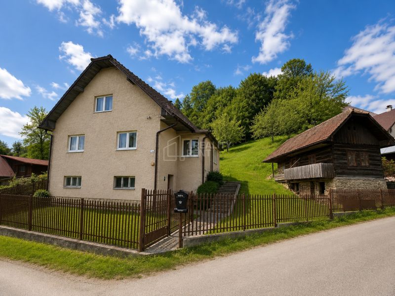 A family house on Budatínska Lehota Street in Kysucké Nové Mesto, next to a wooden house.
