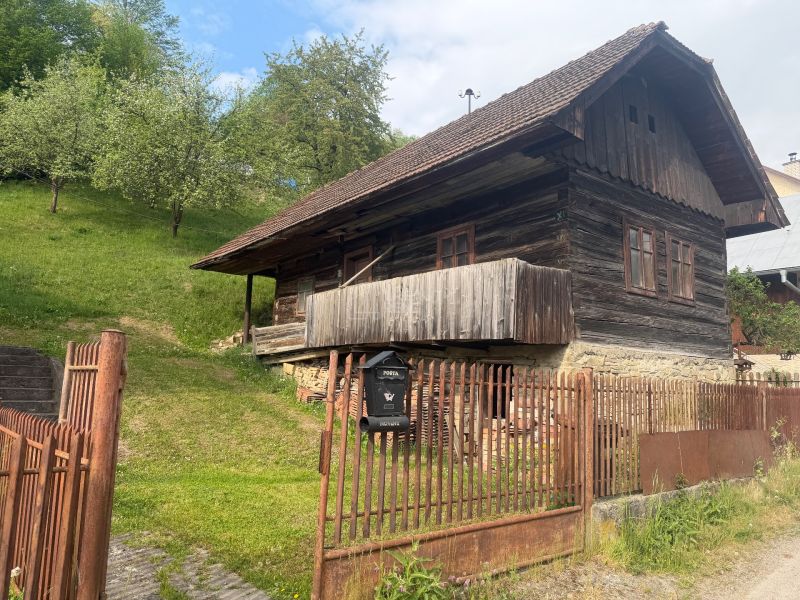 A family house in Budatínska Lehota, Kysucké Nové Mesto with a wooden cottage and green trees.