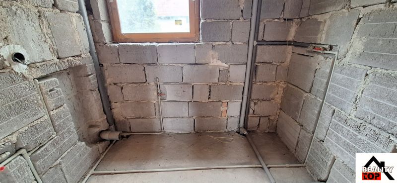 Renovation of a bathroom in a family house with a view of masonry and pipes.