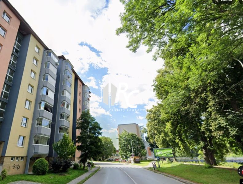 An apartment building on Nábrežná Street in Vrútky surrounded by greenery, suitable for 2-room apartments.