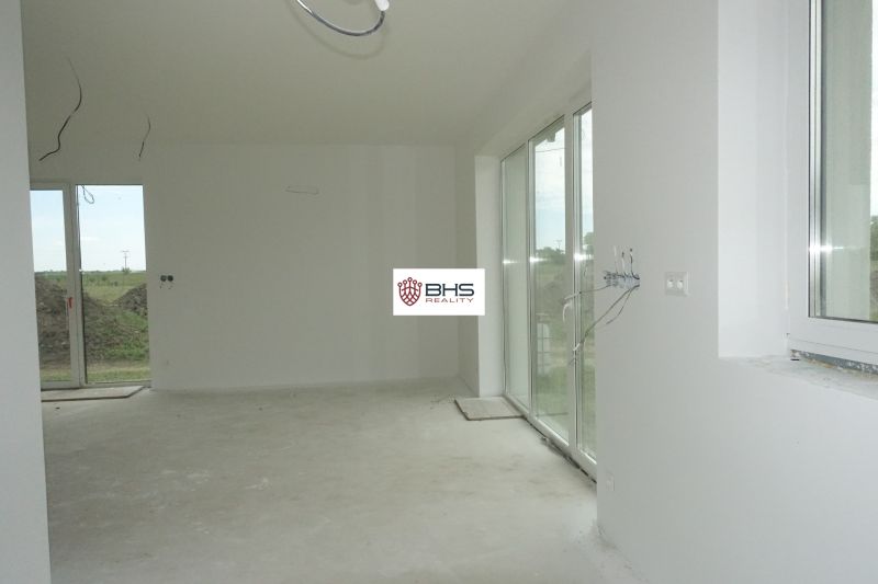 The interior of a family house with large windows and a spacious room.