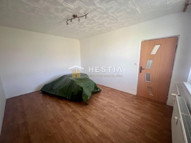 A bedroom in a 3-room apartment with a wooden decor floor and soft lighting.