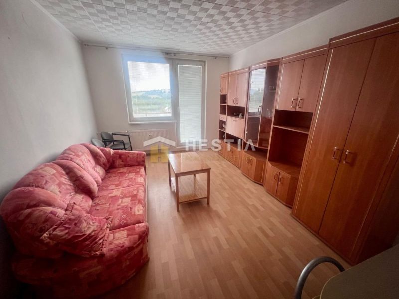 Sofa and furniture in the living room of a three-room apartment, floor with wood decor.