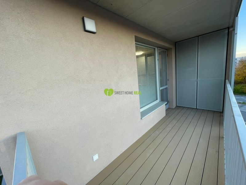 A balcony with wooden decor in a 2-room apartment.