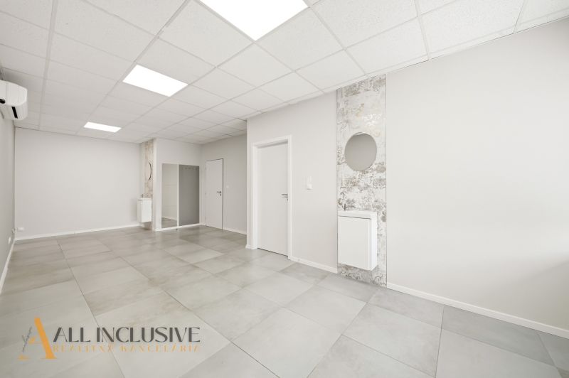 The interior of commercial spaces with white walls and tiles.
