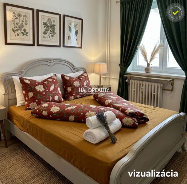 Bedroom with a floral motif on the bed in a 3-room apartment, green curtains, paintings on the wall.