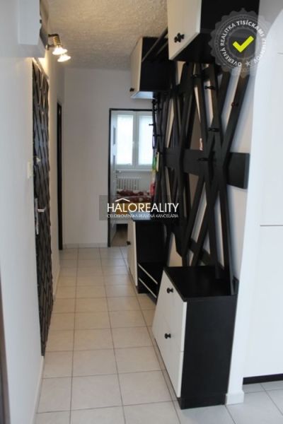 Hallway in a 3-room apartment with a tiled floor, modern furniture, and decorations.