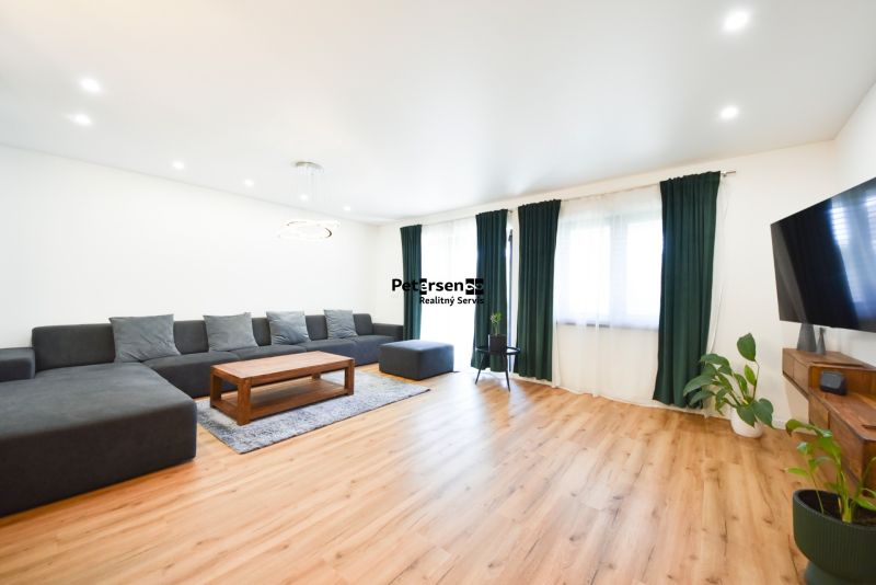Living room in a family house with a comfortable sofa and a wooden decor floor.