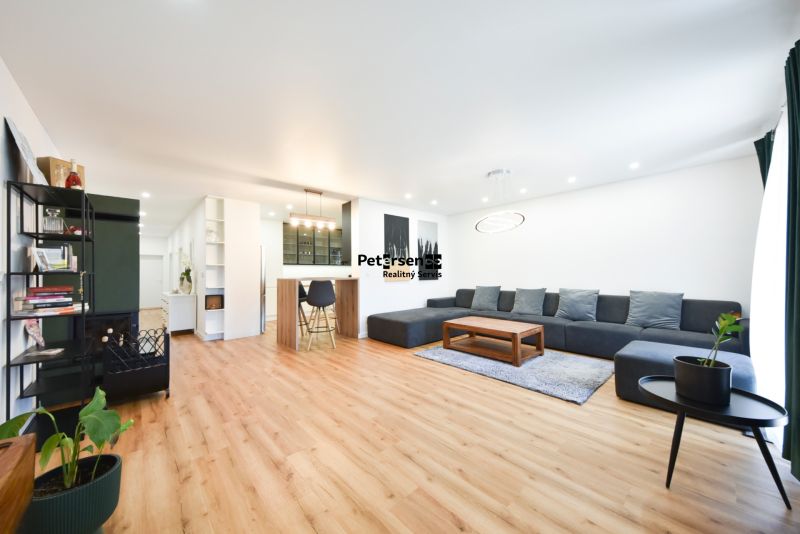 Living space in a family house with a comfortable sofa and a wooden decor floor.