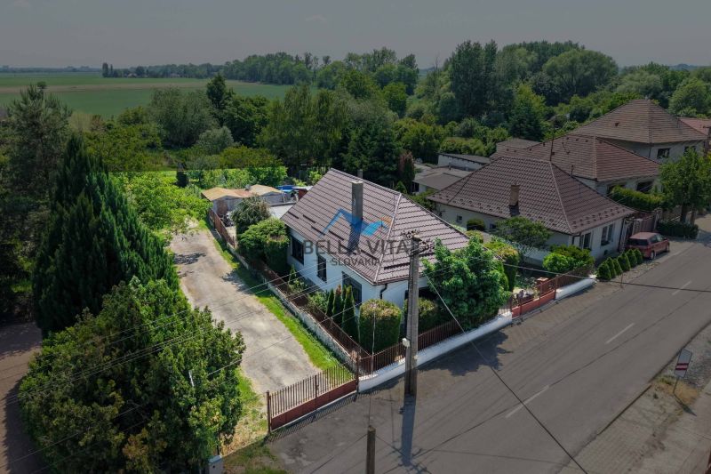 A family house in Topoľnica, on Topoľnica street, surrounded by greenery and an adjacent plot.