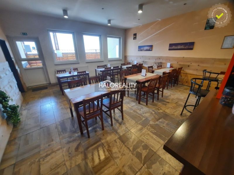 Interior of a gastro space with wooden tables, chairs, and a floor with a wooden decor.