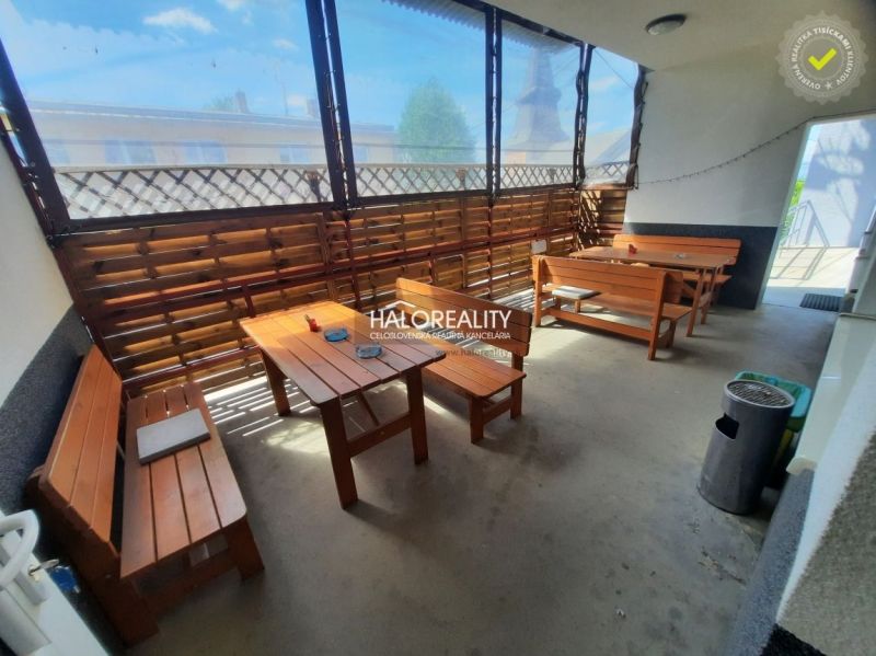 Gastro premises with wooden seating, pleasant atmosphere, and natural light.