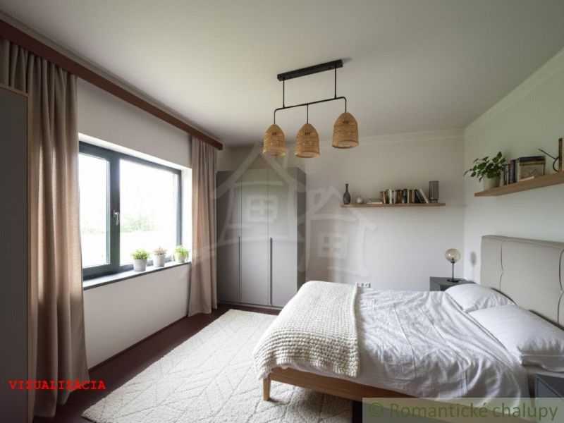 A bedroom in a cottage with a comfortable bed, an open window, and decorations on the shelves.