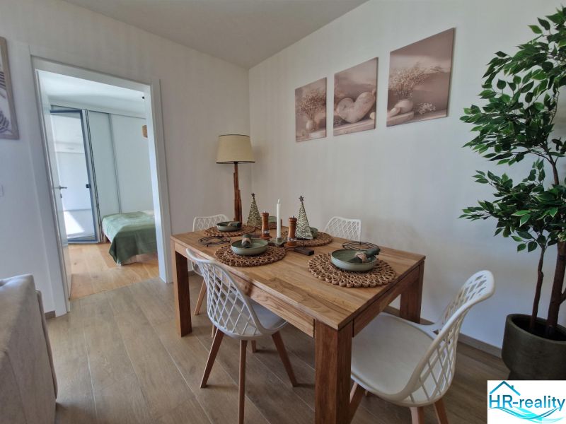 Dining room in a 3-room apartment with a table and decorative accessories.
