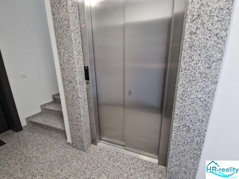 Entrance hall with elevator and stairs in a 3-room apartment.