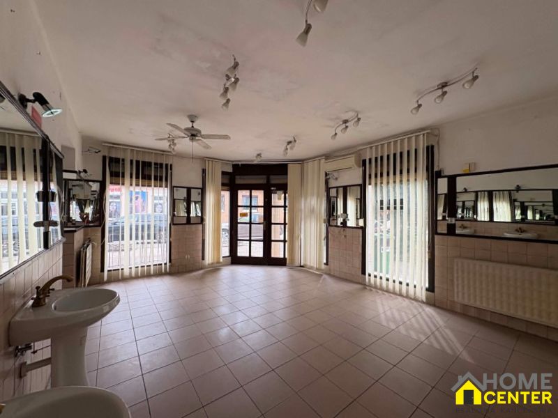 Spacious commercial spaces with sinks and mirrors, suitable for various uses.