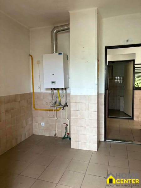 Commercial premises with a gas boiler and tiled floor.