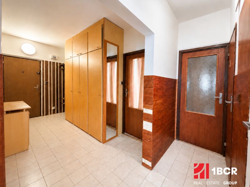 Entrance hallway with a large built-in wardrobe in a 3-room apartment, tiled floor.