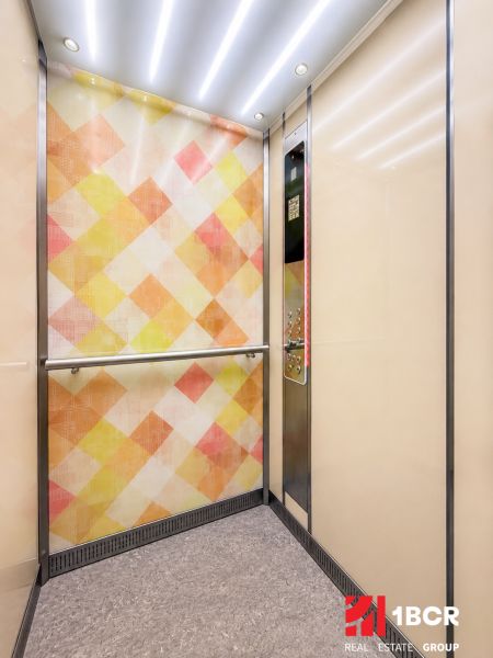 An elevator with a colorful wall and subtle lighting, ideal for a 3-room apartment.