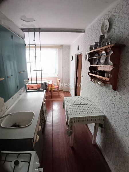 A kitchen with older furniture and decor in a 3-room apartment.