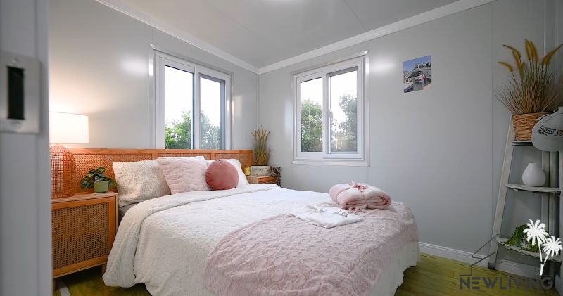 A bright bedroom in a family house with pink decorative elements and wooden floor decor.