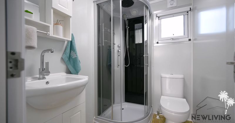 A bathroom with a modern shower and sink in a family house.