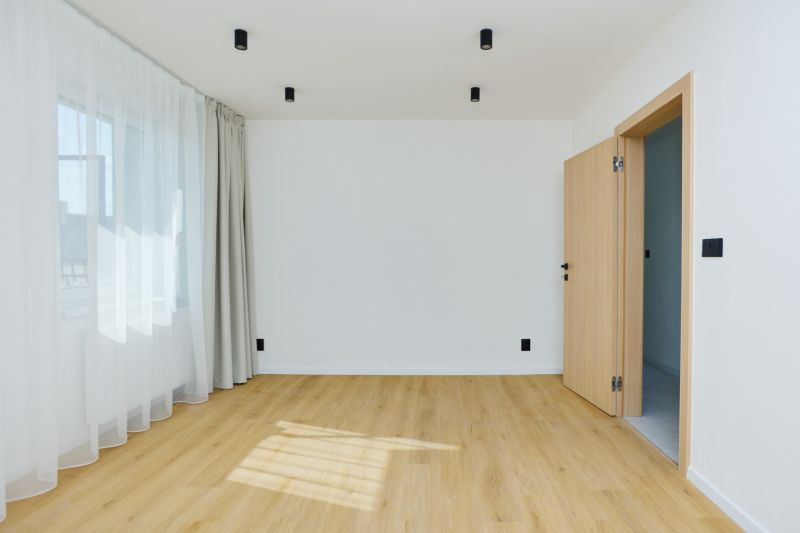 A room in a 4-room apartment with a wood-patterned floor and curtains.