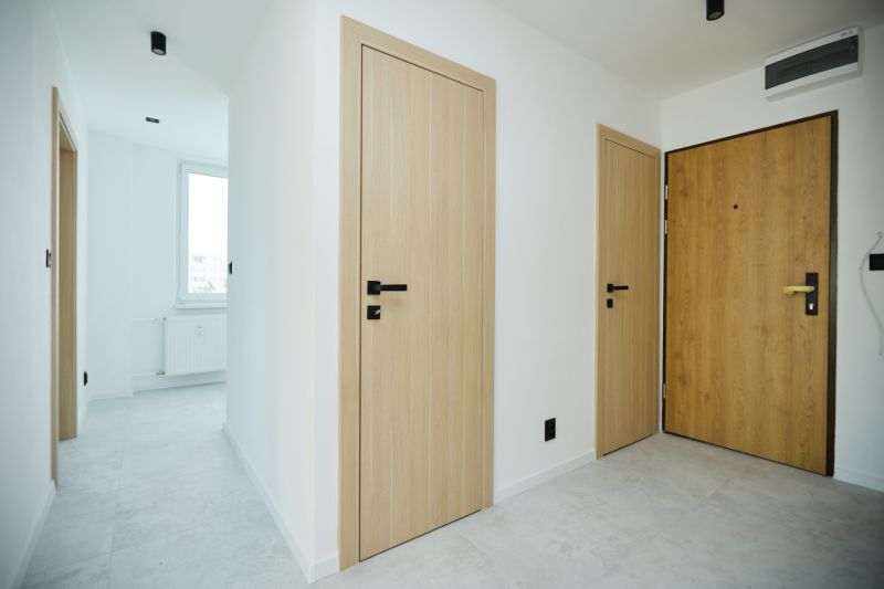 Interior of a 4-room apartment with a wooden decor floor and light doors.