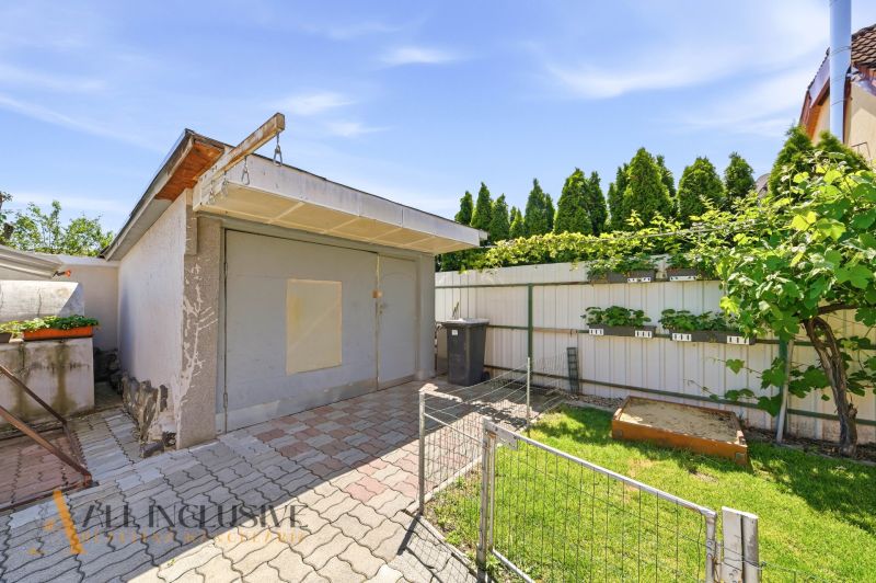 A family house in Gabčíkovo with a garage, terrace, and planter boxes in the garden.