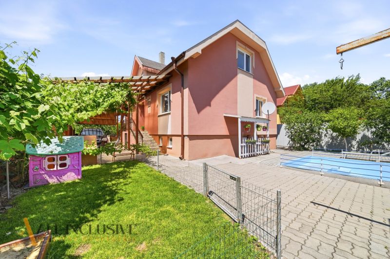 A family house in Gabčíkovo with a swimming pool, a children's playhouse, and a terrace in the garden.