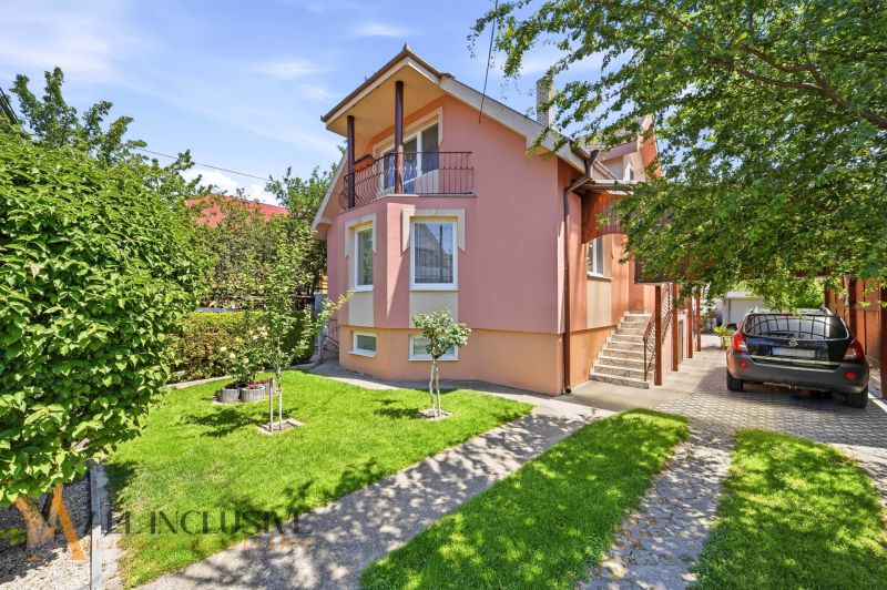 A family house in Gabčíkovo with a landscaped garden, garage, and sunny facades.