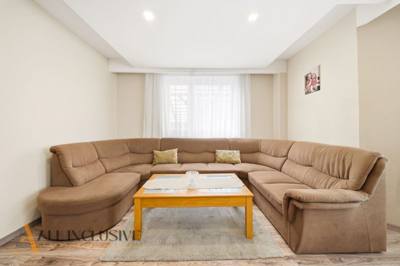 Bright living room in a family house with a comfortable sofa and a coffee table.