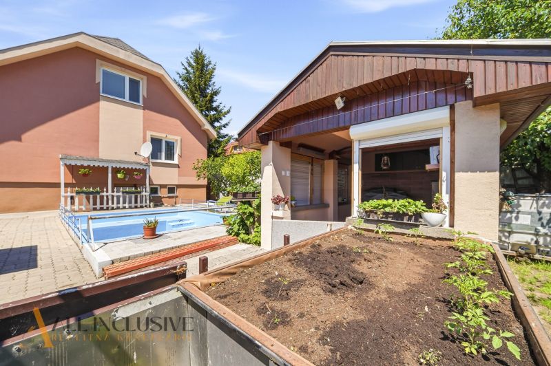 A family house in Gabčíkovo with a swimming pool and a terrace for growing plants.