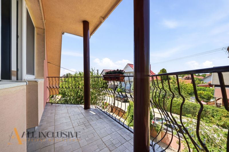 A balcony of a family house in Gabčíkovo with floral decorations and a view of the surroundings.