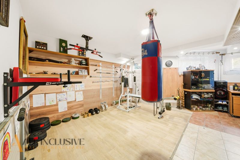 Home gym with a punching bag and flooring with a wooden decor.