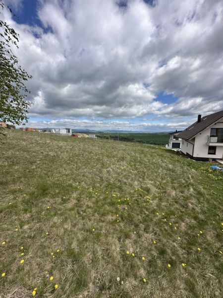 View of a residential plot in Malý Slavkov with a panoramic view of the landscape.