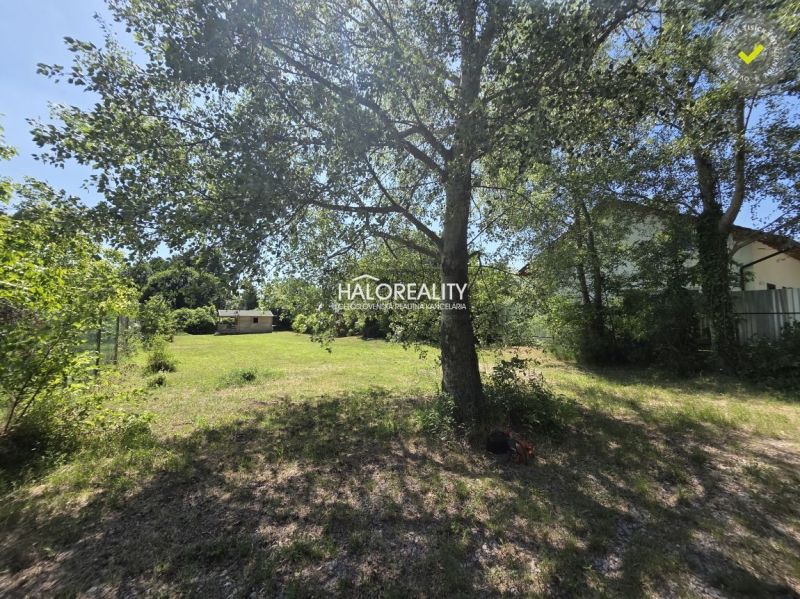 Garden plot in Potônske Lúky, ideal for living, surrounded by trees and greenery.