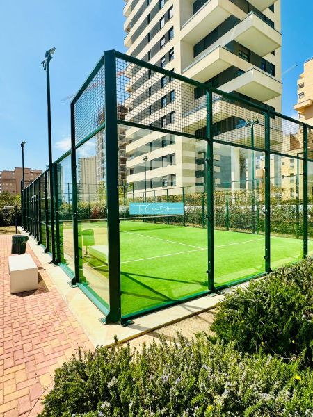 The exterior of a padel court near high-rise buildings in the city of Calpe.