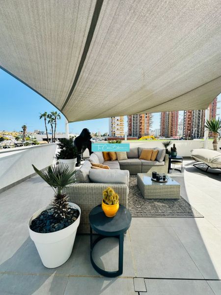 Spacious terrace at a 3-bedroom apartment in Calpe with comfortable seating and plants.