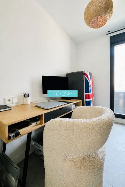 A work corner with a wooden desk and chair in a 3-room apartment.