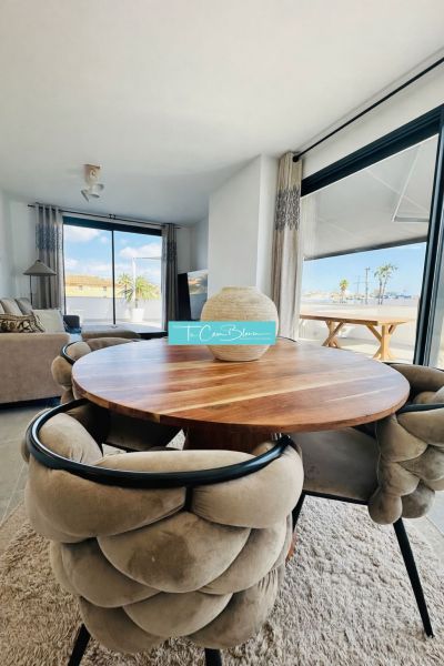 Dining table with comfortable chairs in a 3-room apartment with large windows.