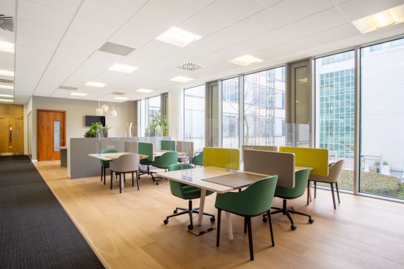 Bright offices with comfortable chairs and wood-patterned flooring.