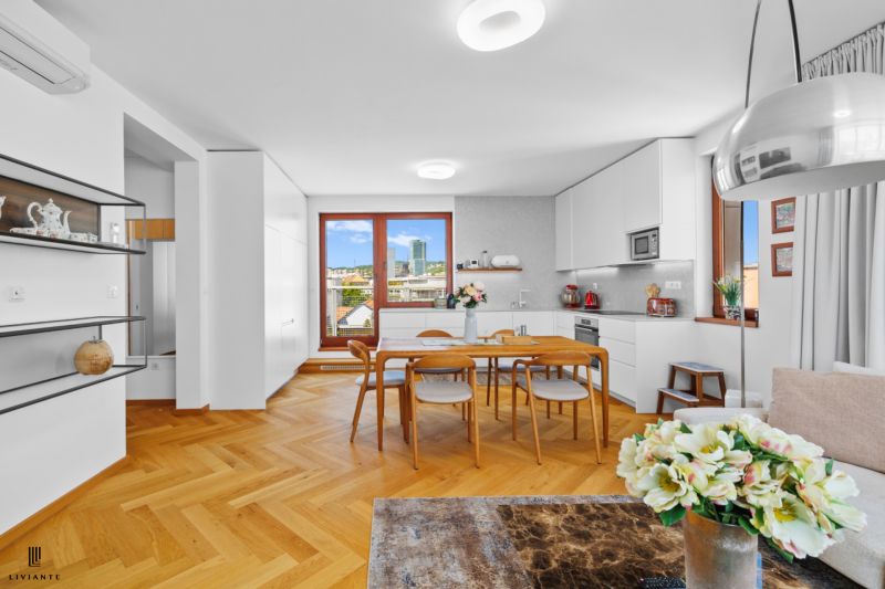 A kitchen with built-in cabinets and dining area, wooden decor flooring, 4-room apartment.